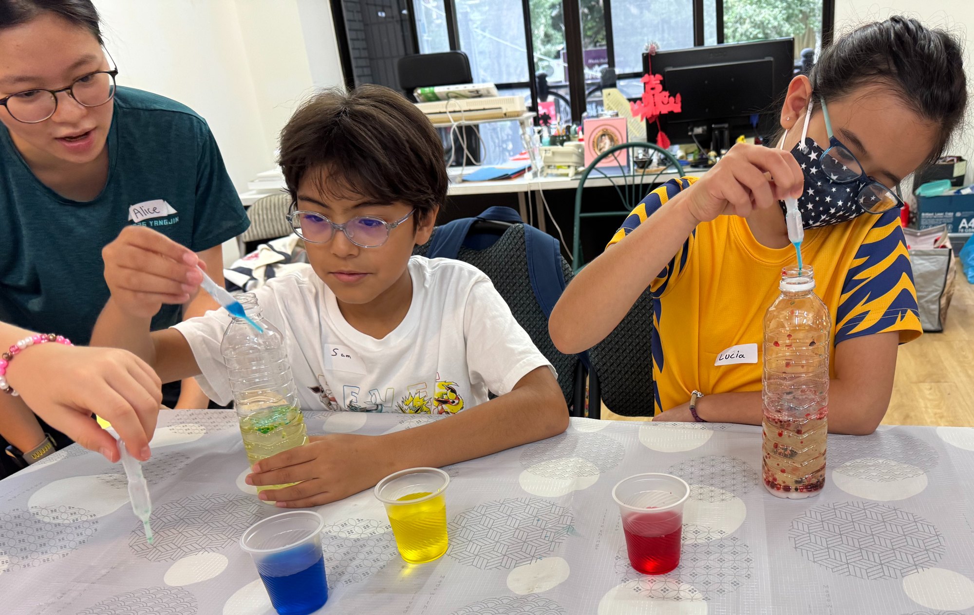 Children and a mentor exploring science together